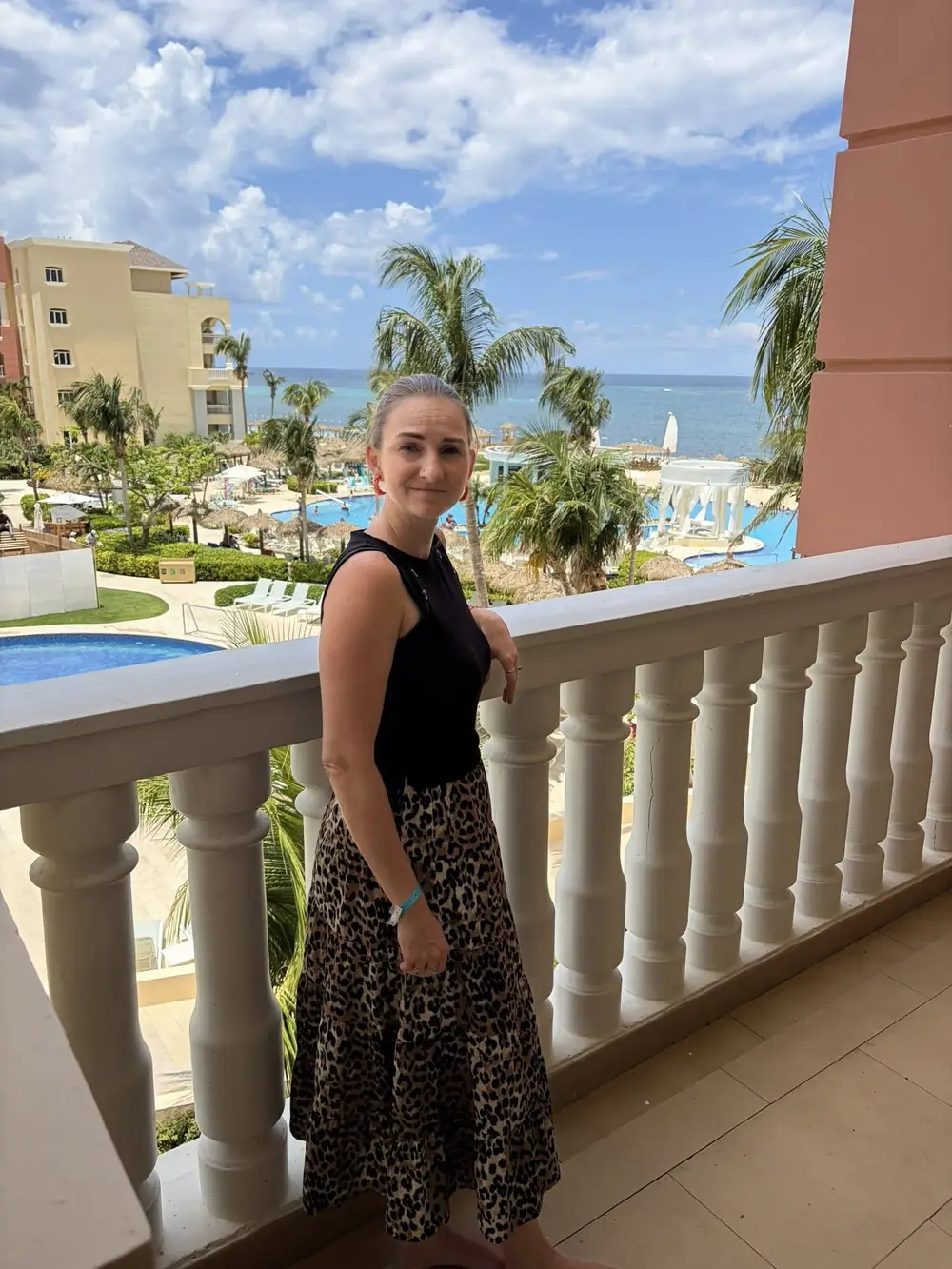 Rachel at an all-inclusive resort overlooking the pool and ocean